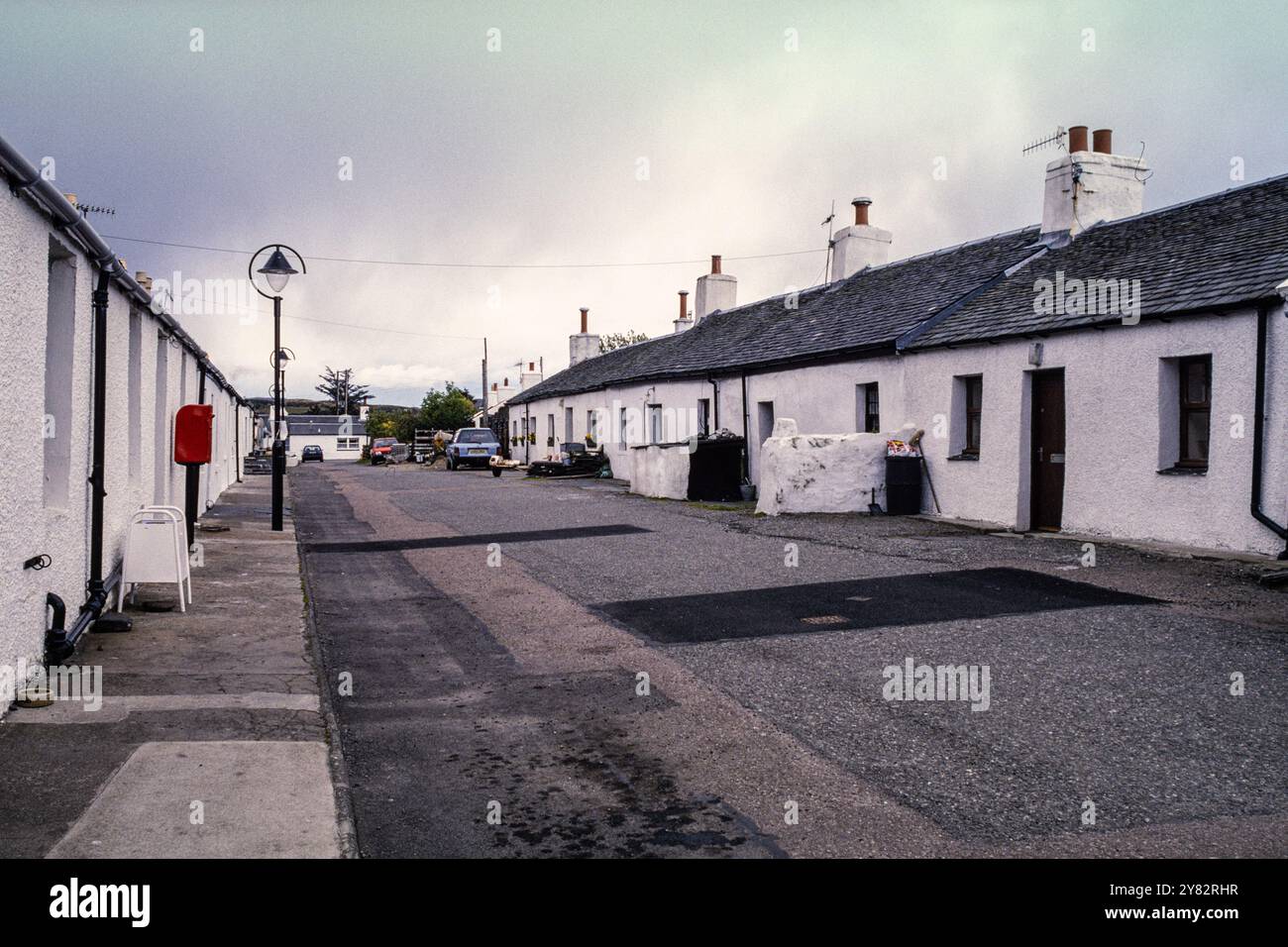 Ellenabeich, a former slate-mining village on the Isle of Seil, West Scotland, UK. Old slate quarry-workers cottages photographed in 1996 Stock Photo