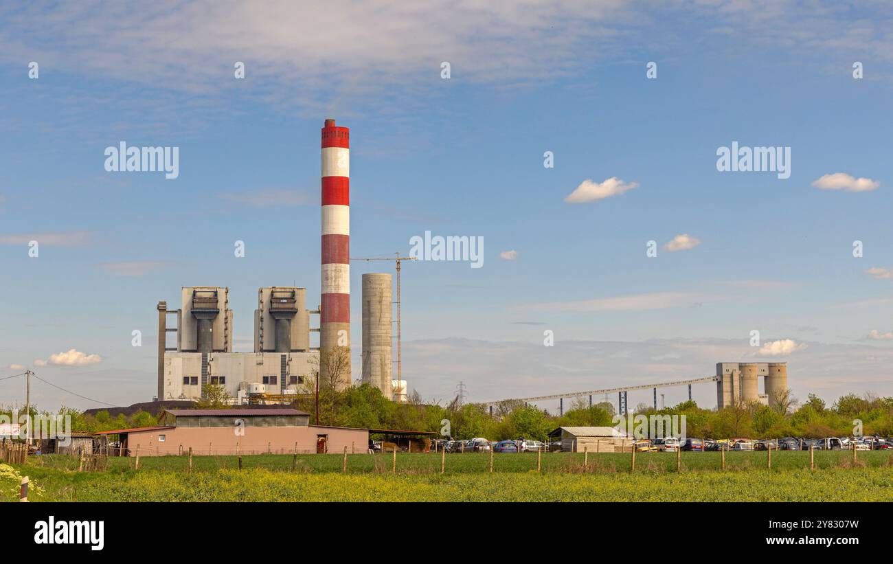 Obrenovac, Serbia - April 04, 2024: Red and White Chimney at Thermal Power Plant Station Facility Spring Day. Stock Photo