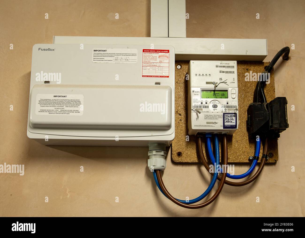 Electric meter and fuse box installed on a wall for monitoring residential electricity usage and distribution Stock Photo