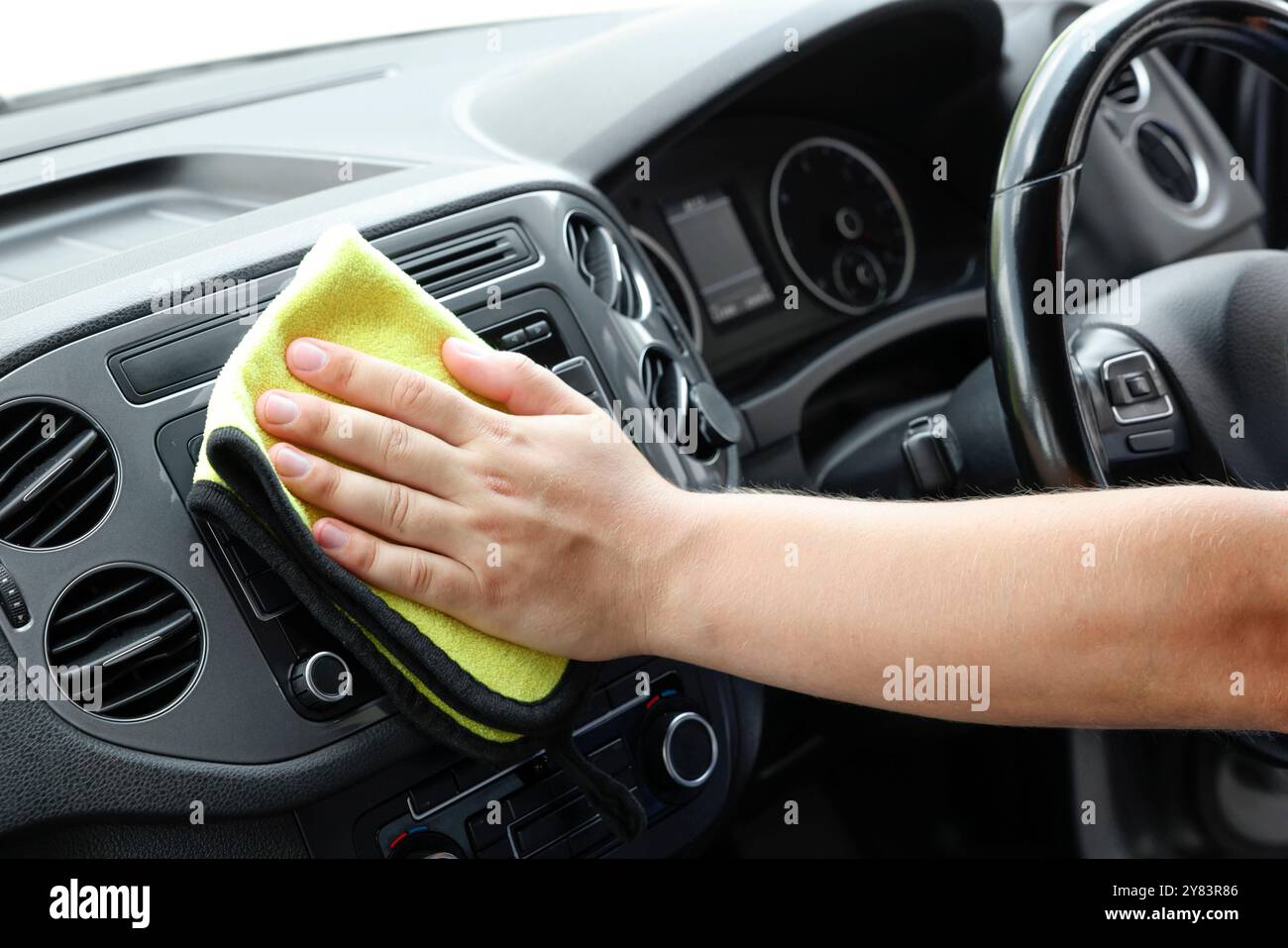 Man cleaning center console with rag, closeup Stock Photo - Alamy