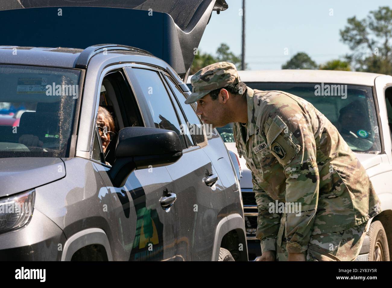 Live Oak, Florida, USA. 2nd Oct, 2024. Sgt. Nicholas Andrews with the Florida Army National Guard's 753rd Brigade Engineer Battalion, 53rd Infantry Brigade Combat Team, greets local residents to ask what supplies they need, at the Live Oak, FL point of distribution, Oct. 2, 2024. Many of the Florida National Guard run PODS have started to wind down, but a group of 753rd BEB Soldiers, like Andrews, have volunteered to stay on longer in order to assist with areas like Live Oak, which are still in need of supplies. (Credit Image: © U.S. Navy/ZUMA Press Wire) EDITORIAL USAGE ONLY! Not for Comm Stock Photo