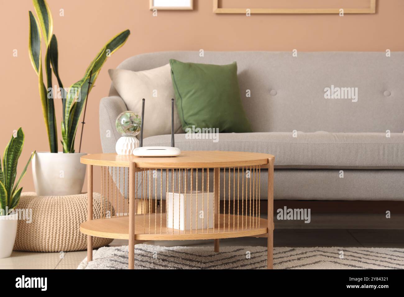 Interior of living room with sofa and wi-fi router on table Stock Photo ...