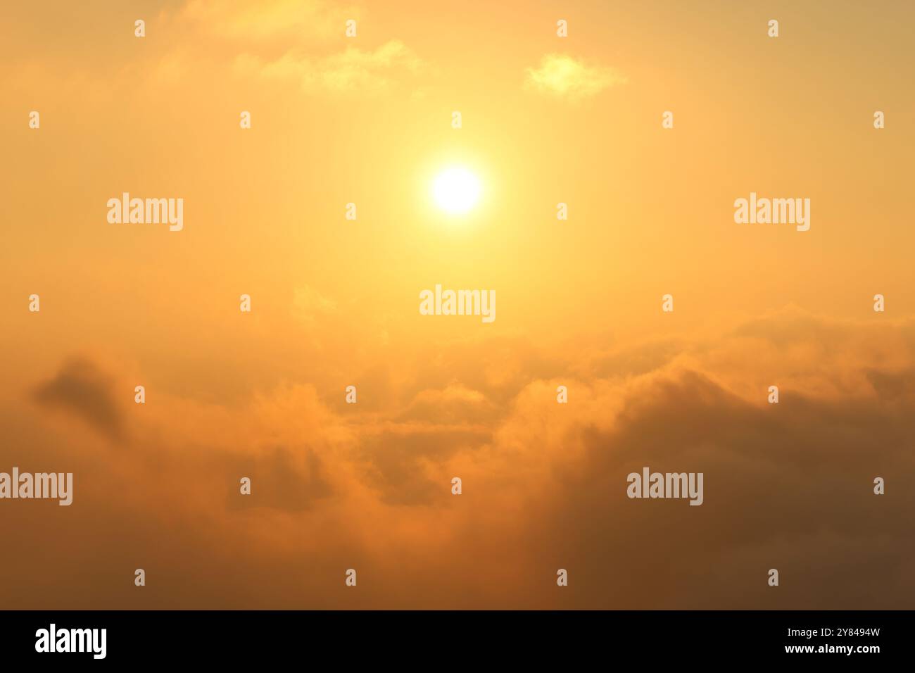 A magical sunset high over the clouds. Stock Photo