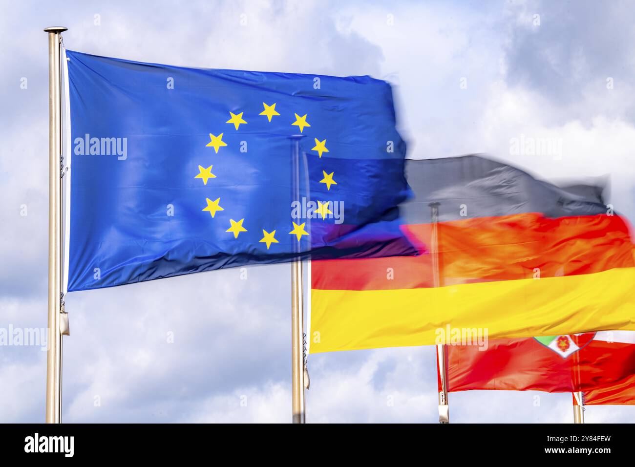 Waving flag of the European Union, Germany flag, state flag of North Rhine-Westphalia Stock Photo