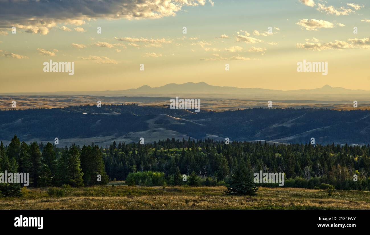 Sunset over a long valley with mountains in the distance Stock Photo