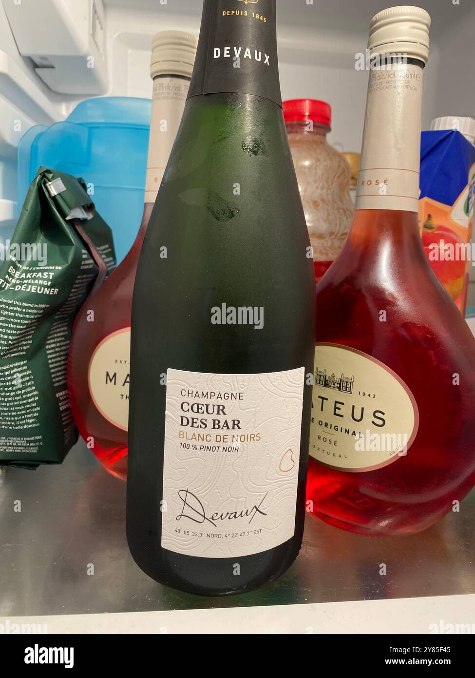 Cold bottle of Champagne in a fridge Stock Photo