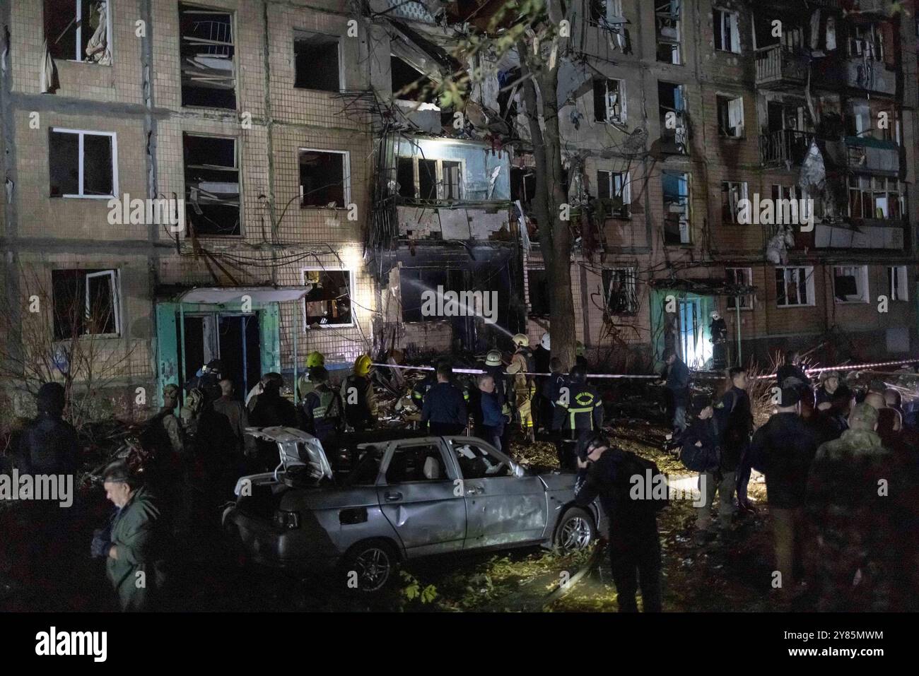 Rescue workers clear the rubble of a building damaged by a Russian ...