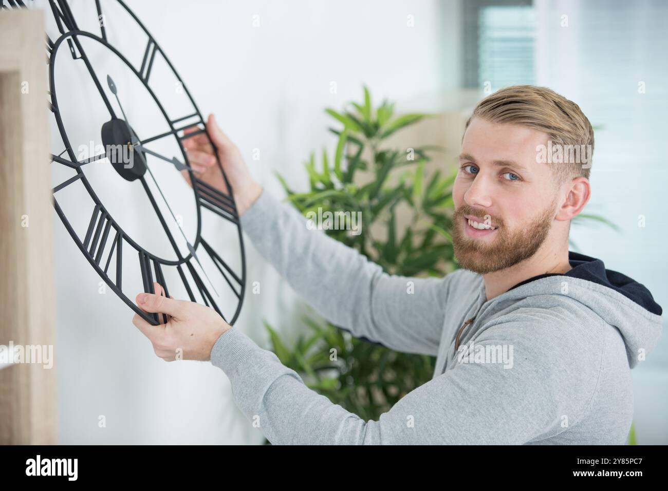 Man Changing Time Changing time on a large clock hi-res stock photography and images - Alamy