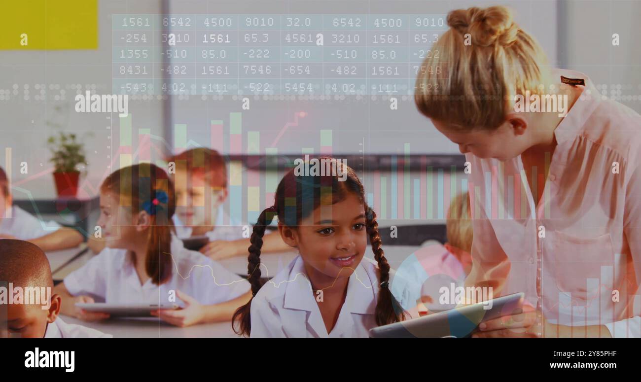 Children using tablets in classroom with data processing image over them Stock Photo