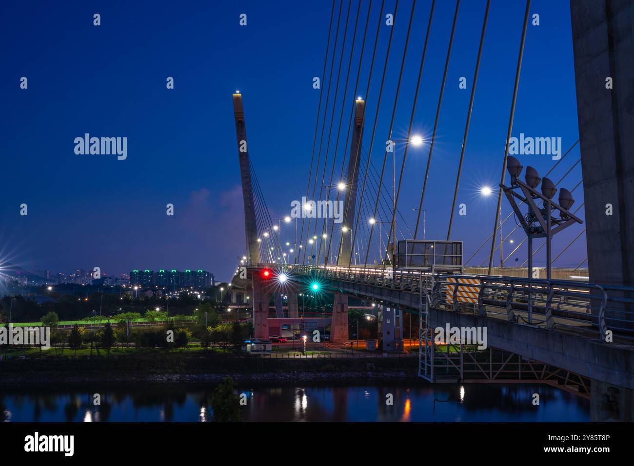 This photo shows the night view of a bridge, with bright streetlights ...