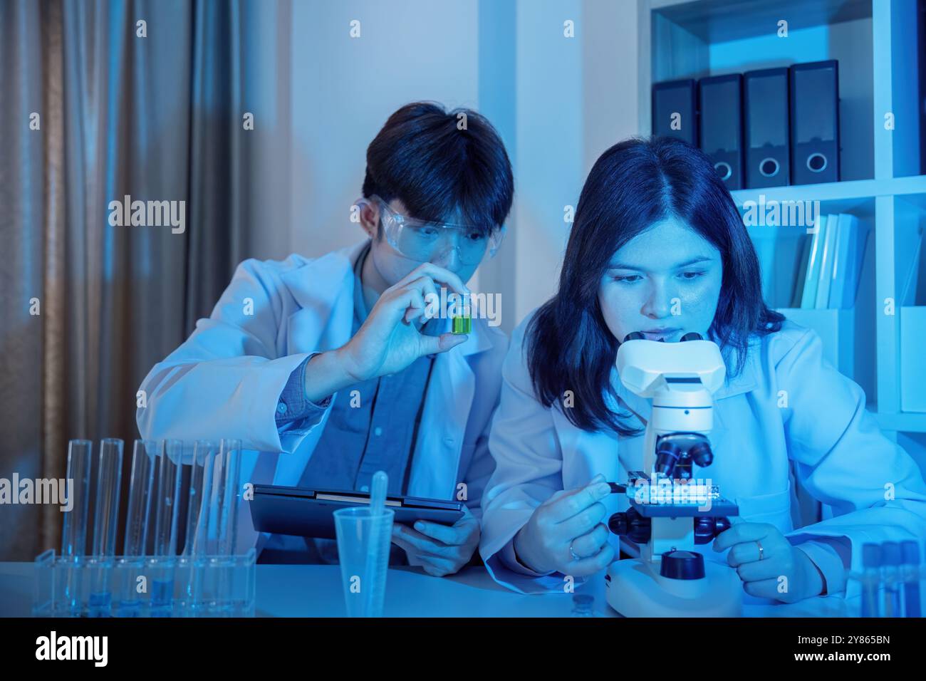 Scientists Conducting Experiments in a Modern Laboratory Setting with Advanced Equipment and Technology Stock Photo