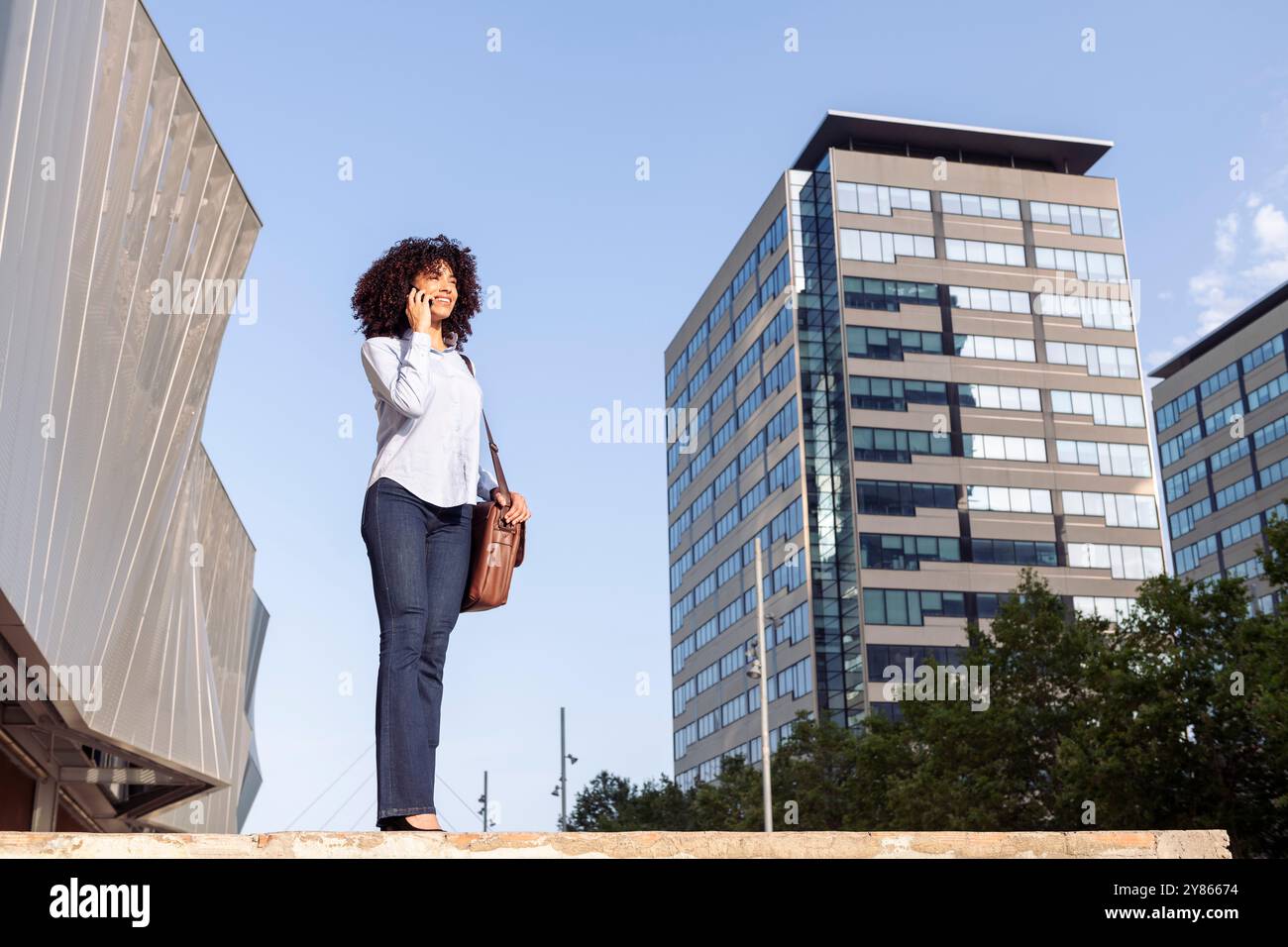cheerful female entrepreneur talking on phone Stock Photo