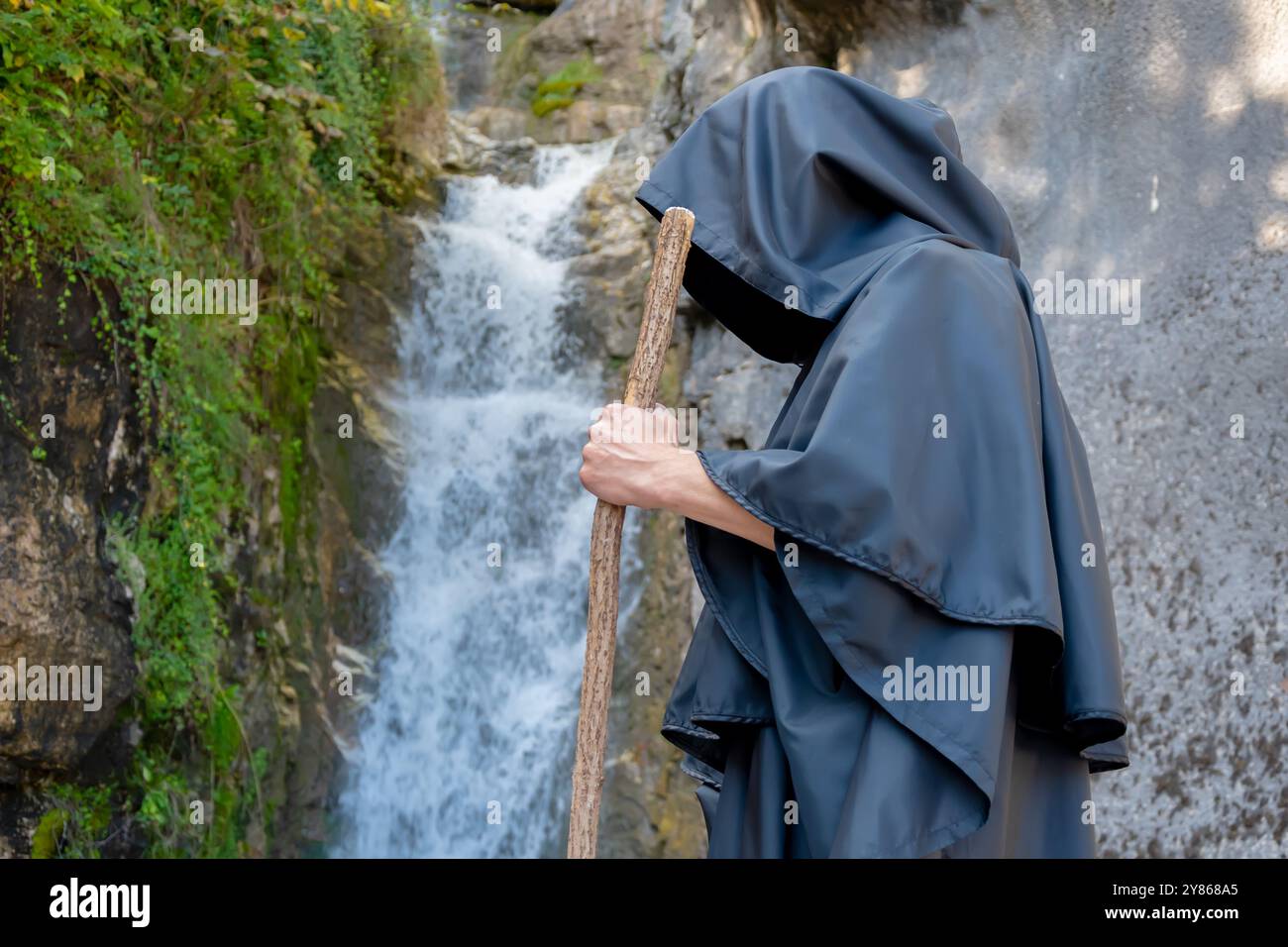 Elderly monk in black cloak hi-res stock photography and images - Alamy