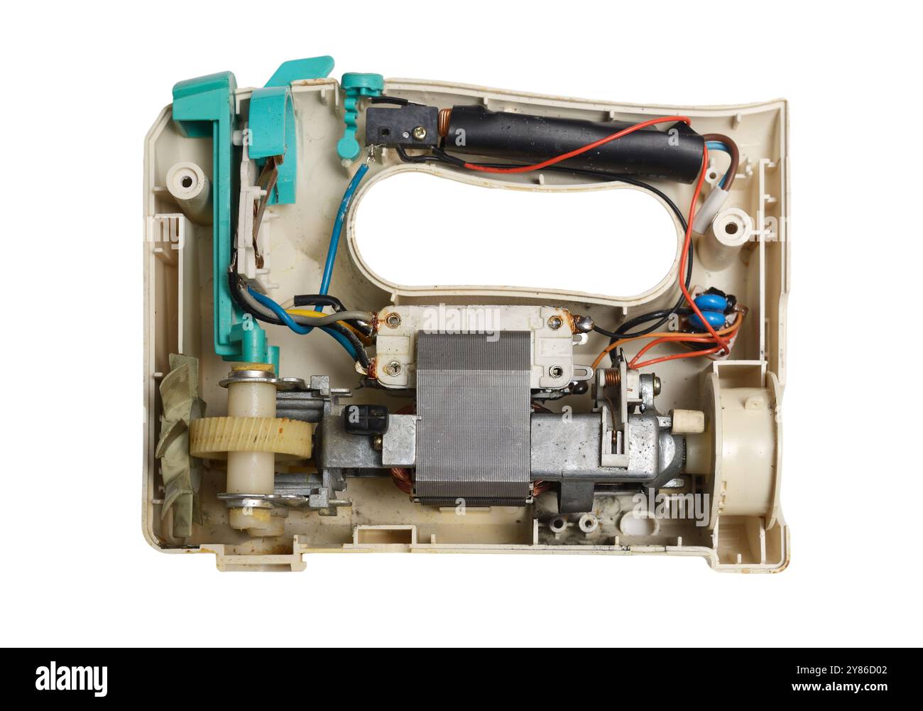 This image shows the inner mechanism of a kitchen mixer, with visible gears, motor, wiring, and plastic casing. The disassembled appliance reveals the Stock Photo