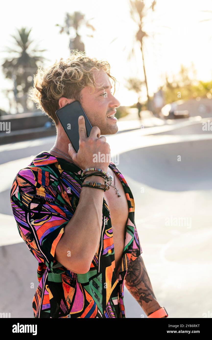 stylish millennial guy using mobile phone Stock Photo