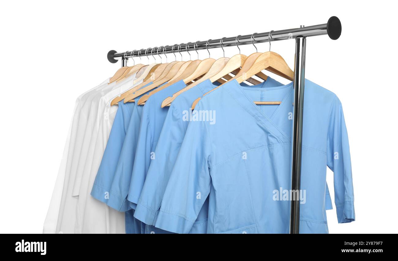 Medical Garment Rack Different medical workers' uniforms on clothing rack against white ...