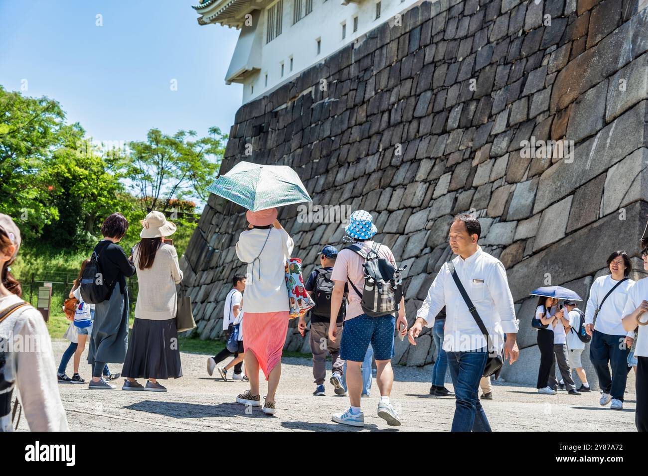 Osaka, Japan - 05.05.2024: Crowd of tourists visiting Osaka Castle, the most famous landmark and popular tourist attractions in Osaka, Japan. Stock Photo