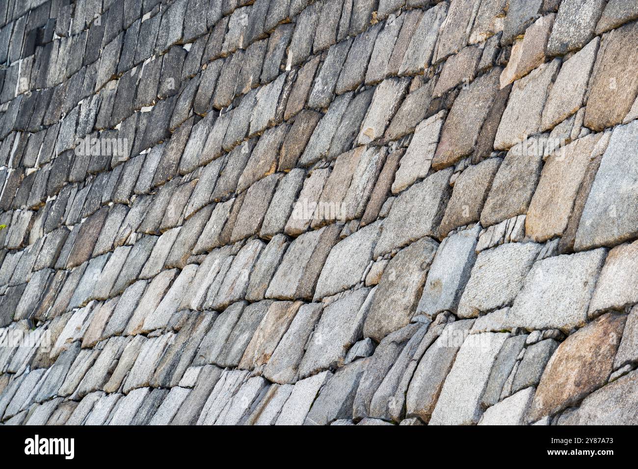 Traditional japanese stone wall moat at the base of Osaka Castle. Texture background. Stock Photo