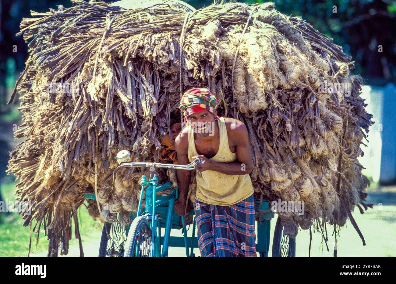 Jutt Raksha Loader Bangladesh, Sadarghat, rickshaw driver transports a load of jute that ...