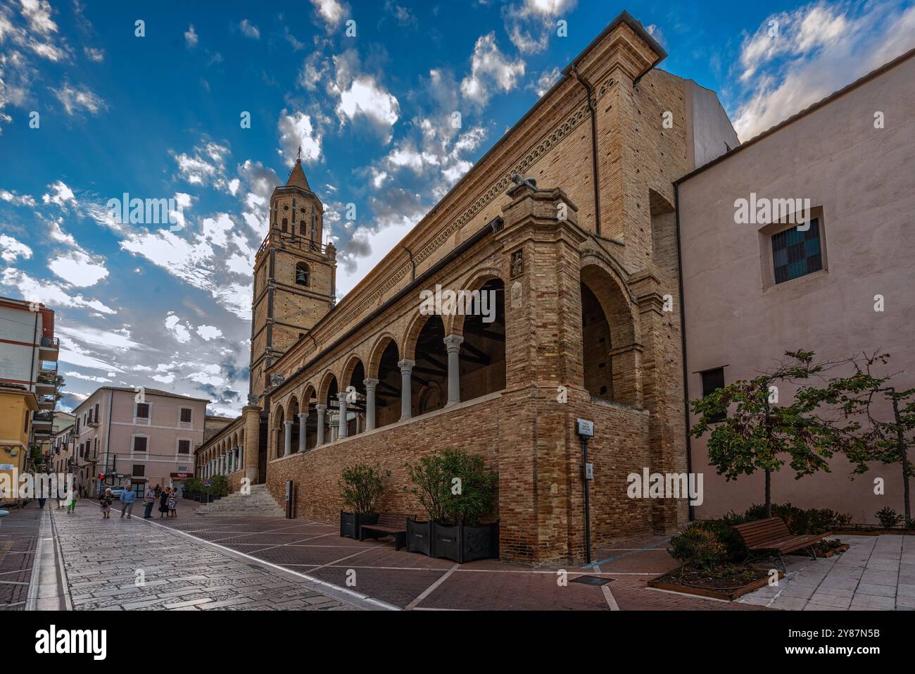 The large 15th century portico and the large spire bell tower of the Collegiate Church of San Michele Arcangelo. Città Sant'Angelo, Abruzzo, Italy Stock Photo