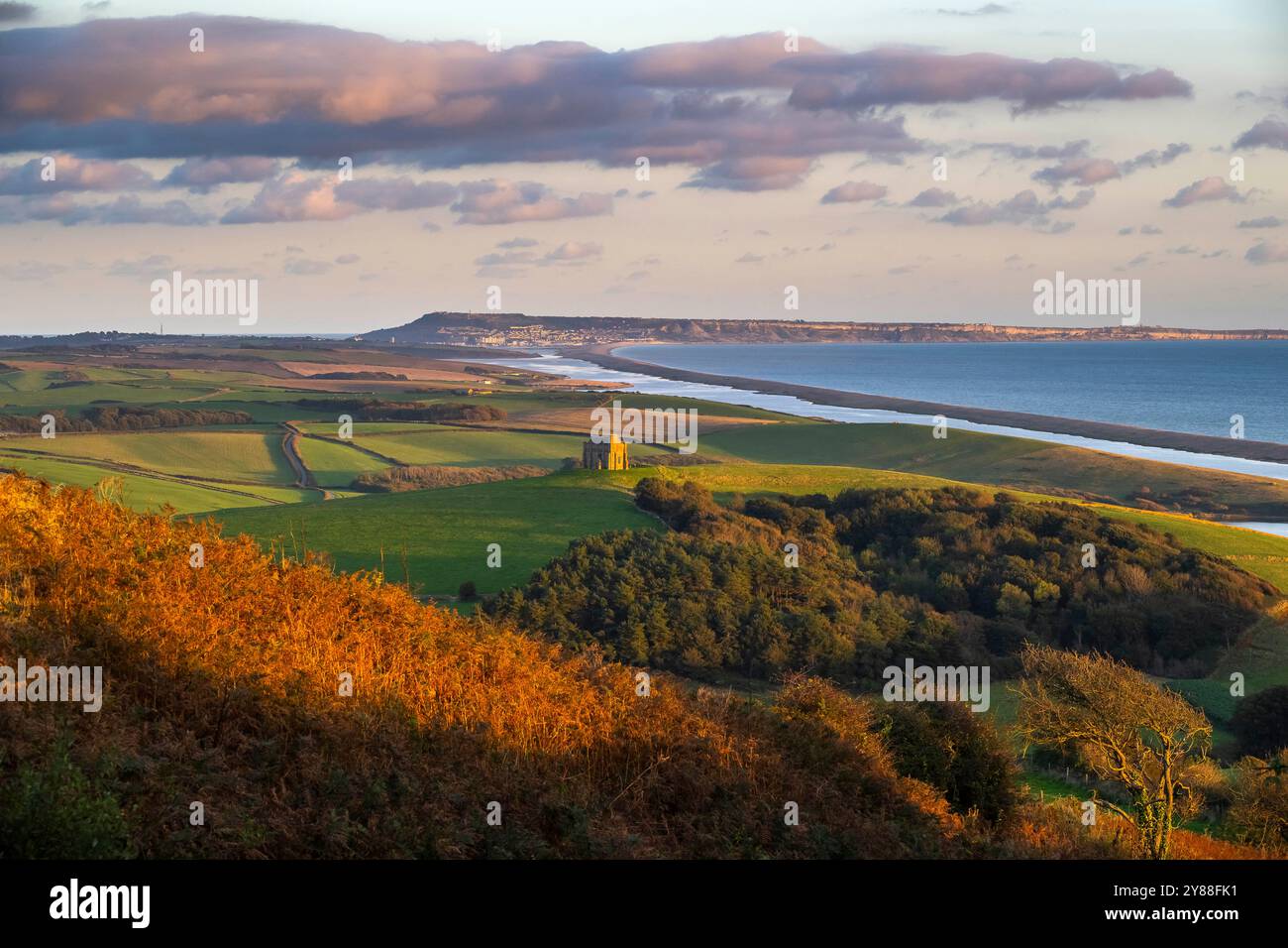 Abbotsbury, Dorset, UK.  3rd October 2024.  UK Weather.  An autumnal view from Abbotsbury Hill looking towards St Catherine’s Chapel and the Fleet lagoon at Abbotsbury in Dorset on an afternoon of warm autumn sunshine.   Picture Credit: Graham Hunt/Alamy Live News Stock Photo