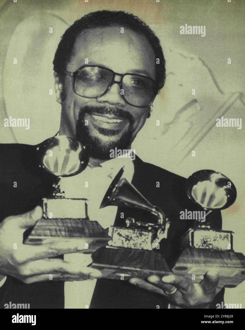 Three Time Winner -- Multi-talented Quincy Jones holds his three Grammy Awards he received Wednesday night during the 24th annual Grammy Awards presentations in Los Angeles. Jones received the awards for the best arrangement on local and instrumental recording, best arrangement accompanying ***** and best rhythm and blues vocal performance by a group. February 24, 1932. (Photo by AP Laserphoto). Stock Photo