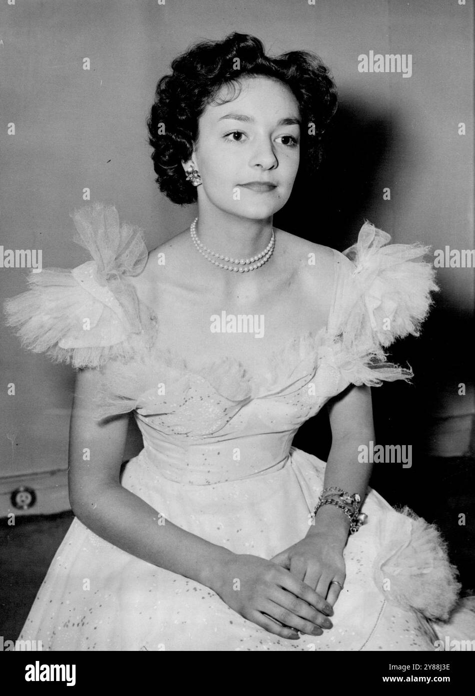 Coronation Maid Of Honour Has First Dress Fitting Lady Mary Baillie-Hamilton, 18-year-old daughter of the Earl and Countess of Haddington, pictured at Norman Hartnell's salon in Bruton Street, London, W. to-day (Thursday). when she had the first fitting of the dress she will wear as a maid of Honour at the coronation ceremony in Westminster Abbey. (The dress is not shown in the picture). Lady Mary, friend of Princess Margaret, is one of six maids of honour chosen by the queen to carry her train at the coronation ceremony. The dresses they will wear are being made by Norman Hartnell. The design Stock Photo