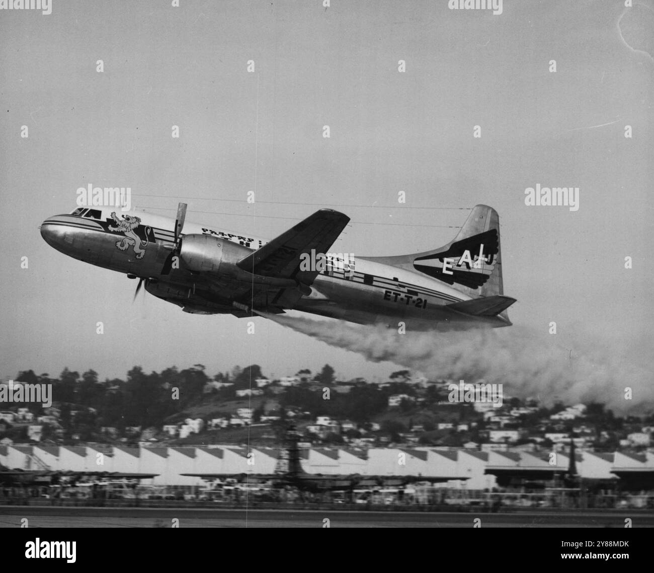 A demonstration single-engine takeoff with Jato (jet-assisted takeoff) is shown here by an Ethiopian Air Lines Convair-Liner in San Diego, California. Ethiopian is the first airline to install Jato as standard equipment. Although the Consolidated Vultee-built transports can take off fully loaded with one engine, Ethiopian has equipped its two Convair-Liners with Jato as a safety precaution when operating from high-altitude airports. The airport at Addis Ababa, Ethiopia, is at an elevation of 7700 feet. One Jato bottle, weighing about 200 pounds, is normally carried. The tremendous thrust lasts Stock Photo