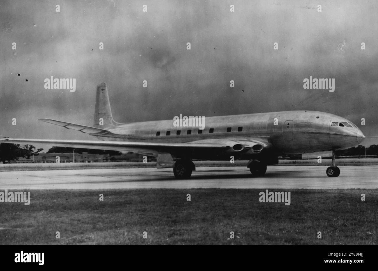 Britain's Jet Airliner 'Hope' Will Do 500 Miles An Hour -- The De Havilland Aircraft Company's 'Comet' jet-propelled airliner - in which there is hope of retrieving the leeway lost in the war when Britain concentrated ***** aircraft - is wheeled out of the factory ***** the first time.This latest ***** in aviation history - the 'Comet' being the ***** jet airliner in the world - is powered by four De Havilland 'Ghost' jet engines, and it is expected ***** at almost 500 miles an hour - the London - Sydney ***** , for instance, will take about 36 hours. The ***** carrying 36 passengers and a cre Stock Photo