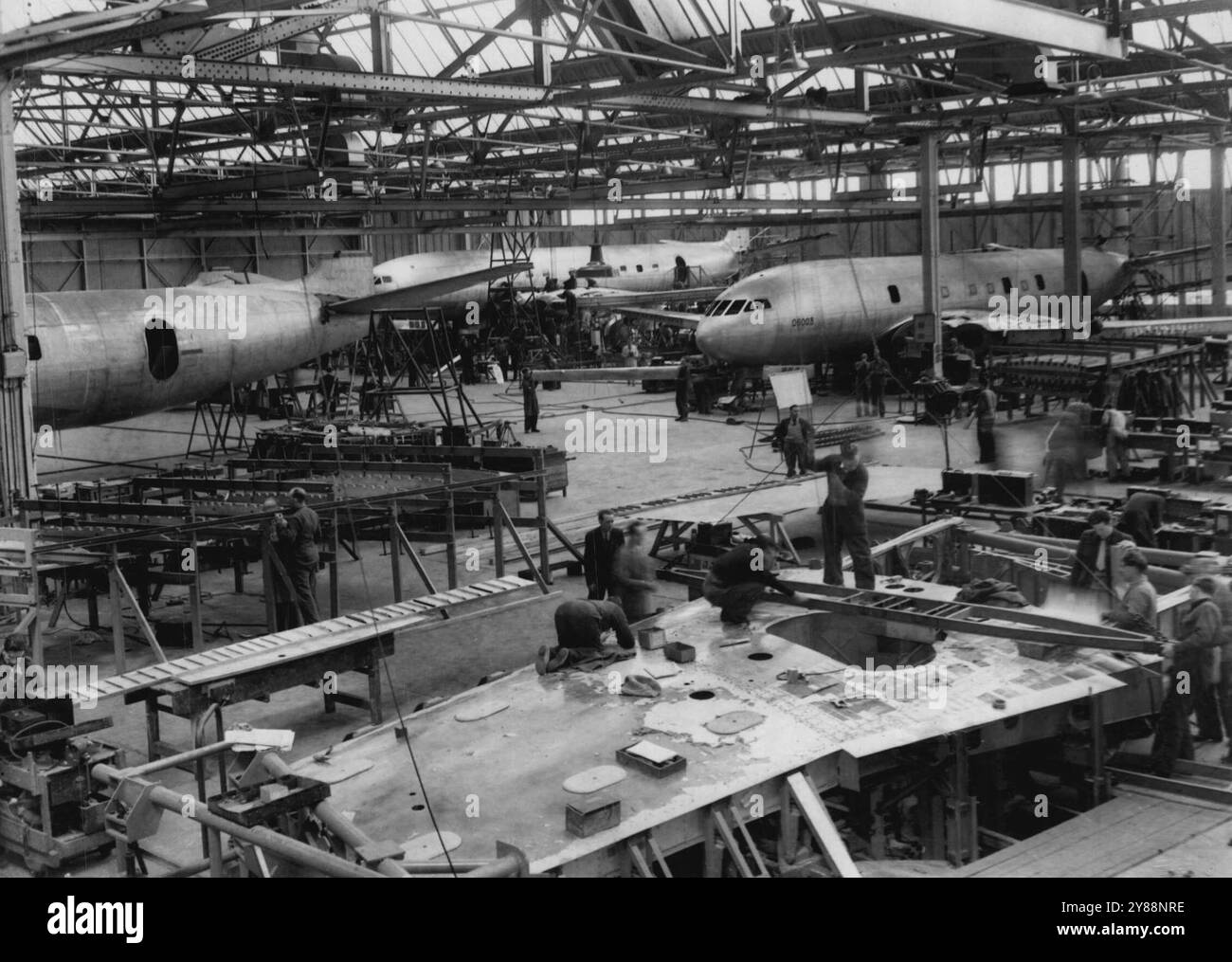 ***** 'Comets' - The World's First Jet Airliners - Under Construction -- A general view of 'Comets' under construction in the Hatfield (Hertfordshire) factory of the De Havilland Aircraft Company.Following the ***** of the world's first jet airliner, the De Havilland 'Comet', which ***** two record-breaking flights to its ***** others are now under construction the de Havilland factory here.***** second 'Comet' is expected to fly ***** the late summer of this year.***** first two to come off the assembly line have been order by the Ministry of Supply on an ordinary commercial basis. March 30, Stock Photo