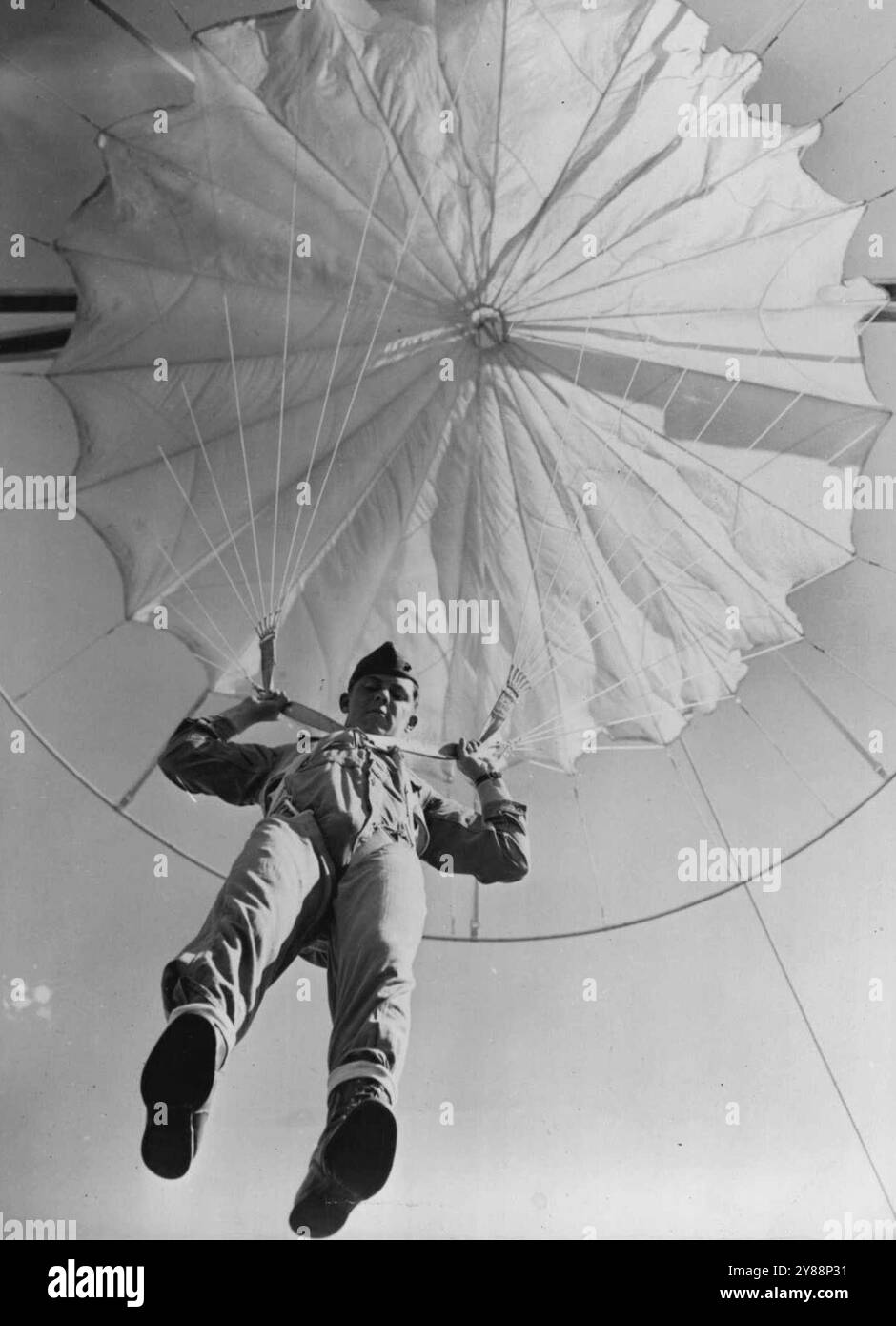 The United States Marines - Now They're Landing From the Air - At 15 feet the parachute blossoms out. The trip to the ground will be exactly as a free ***** but without the drift. August 06, 1942. (Photo by Interphoto News Pictures, Inc.). Stock Photo