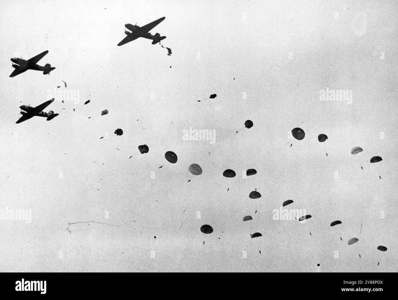 Paratroops Demonstrate for Prime Minister and French Air Craft --Paratroops as they descended from three Dakotas of Royal Air Force Transport Command during the display. fifteen fully-squipped men-all instructors from No.1 Parachute Training School - leaped from each plane 700 feet above ground level and landed on the airfield. Britain's Prime Minister, Mr. Clement Attlee, was accompanied by British and French air experts - including General J.L Piollet, Chief of the air staff of France -when he watched a flying demonstration by aircraft of the Homs Commands, Royal Air Force, at the Royal Air Stock Photo