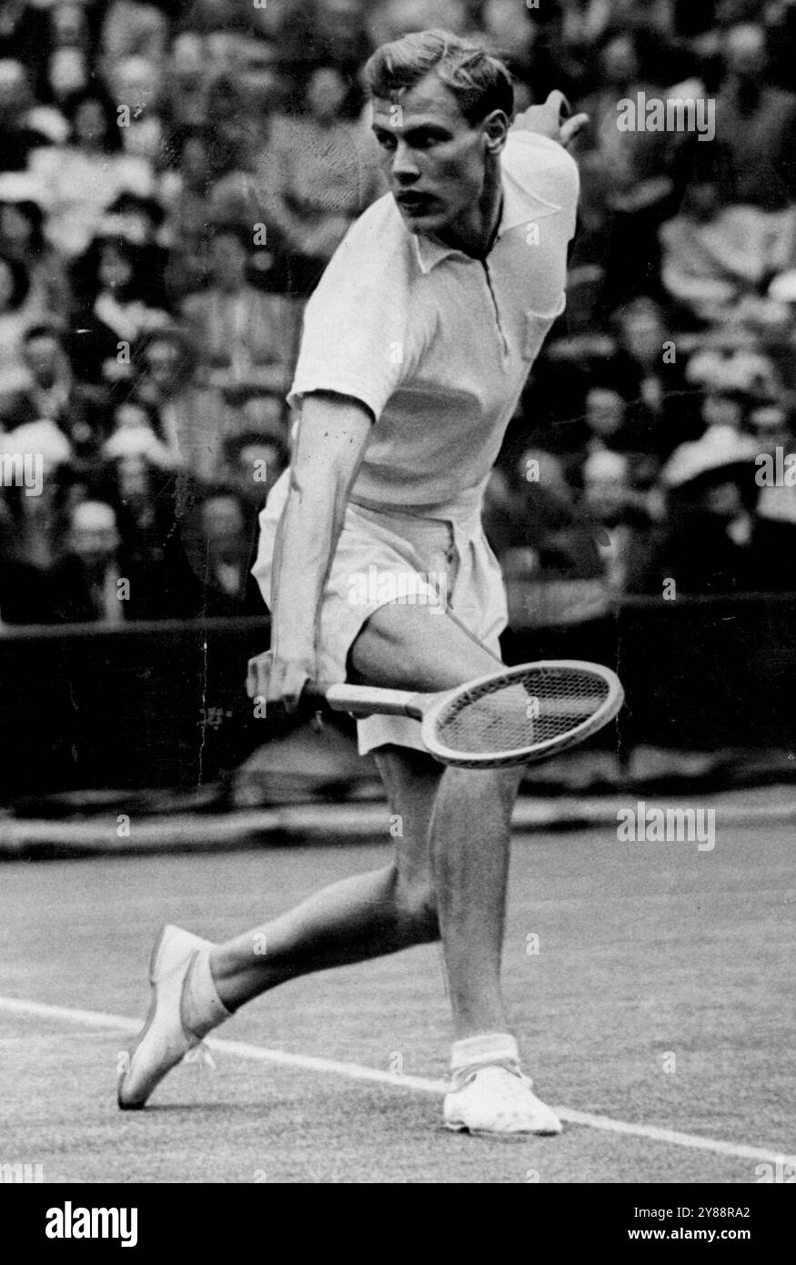 Wimbledon Championships -- Lennart Bergelin (Sweden) in play against Frank Parker (U. S. A.) whom he beat 5-7, 7-5, 9-7, *****, 0-6, 10-8.Lennart Bergelin 23-year-old Swede, to-day brought off the sensation of Wimbledon. He beat Frank Parker, No. 1 seeded player in a three- hour-five - set battle. June 12, 1948. Stock Photo