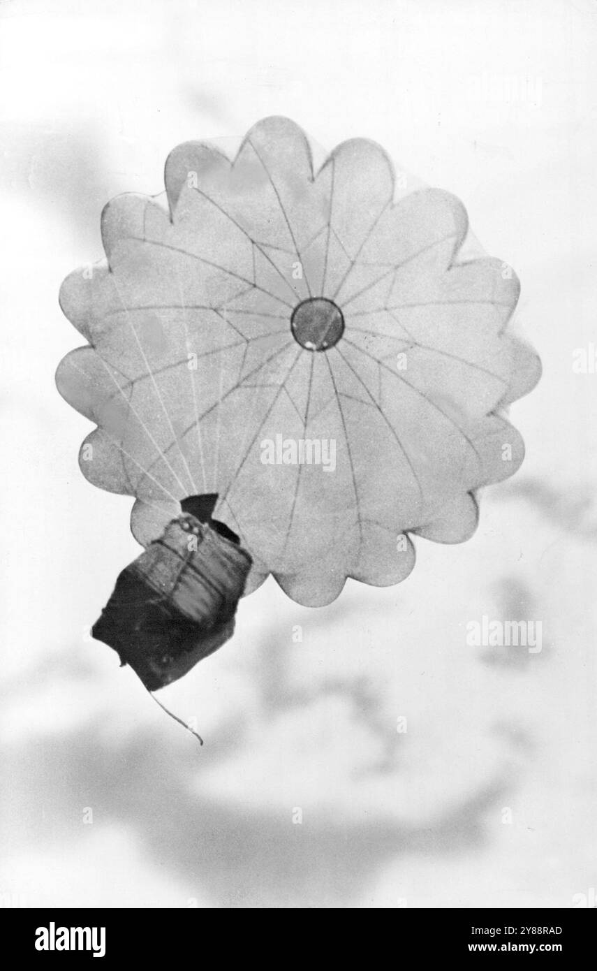 American Troops in Jungles of India --- Supplies for U.S. troops stationed at an outpost near the Burma border in India float down an Army transport plane. Many U.S. soldiers stationed in the jungles areas of India are cut off from the main arteries of supply by the dense jungles. January 01, 1951 Stock Photo