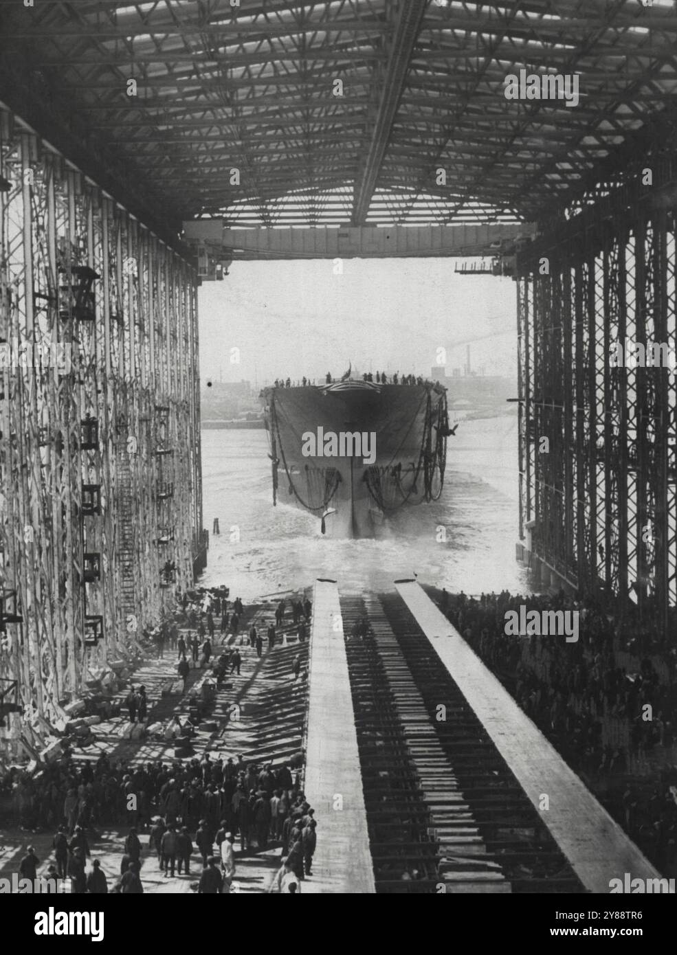 The U.S.S. Saratoga is Launched -- Above is pictured the U.S.S. Saratoga, newest and speediest of airplane carriers, being launched at the N.Y. shipbuilding yards at Coden. Mrs. Curtis D. Wilbur, wife of the secretary of the Navy christened the new ship. April 07, 1925. (Photo by International Newsreel Photo). Stock Photo