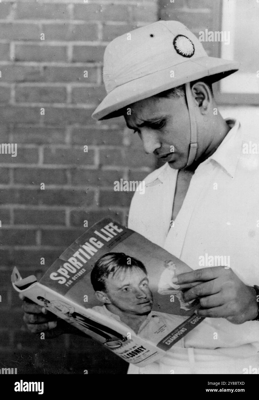 L. Amarnath, Captain of the visiting Indian cricket team, studies Don Bradman's article on captaincy in the October issue of 'Sporting Life'. October 19, 1947. (Photo by Daily News Picture). Stock Photo