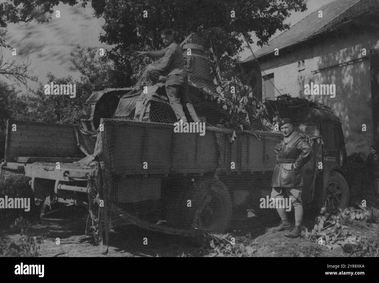 In our machinery Armoured War Char An assault on a truck load is carefully camouflaged before his departure pout lines. Authorised by censorship for France and export. June 02, 1940. Stock Photo