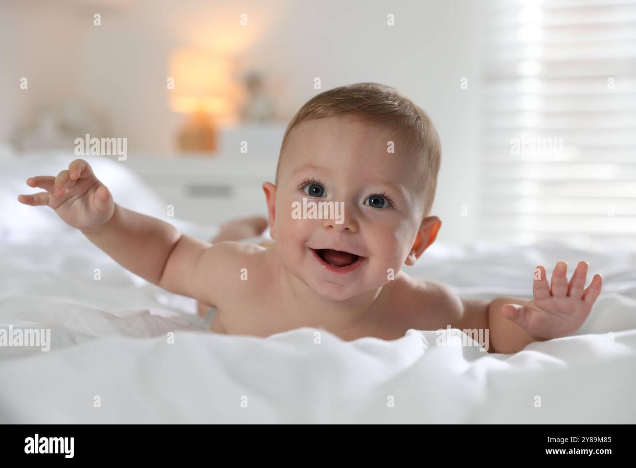 Cute little baby on bed at home Stock Photo - Alamy