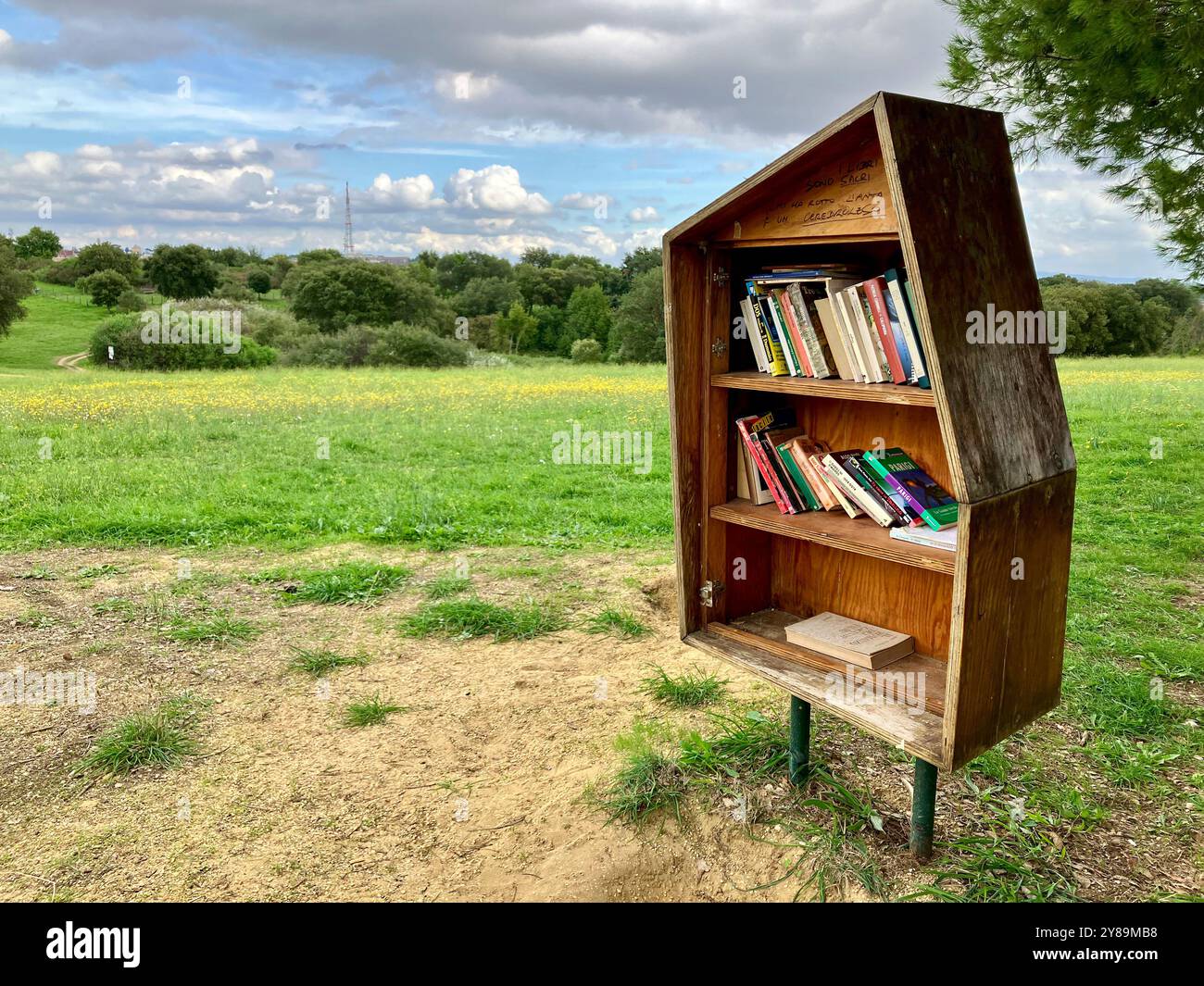 A Little Free Library in Parco Regionale Urbano del Pineto, Rome, Italy, situated in the greenery of the park Stock Photo