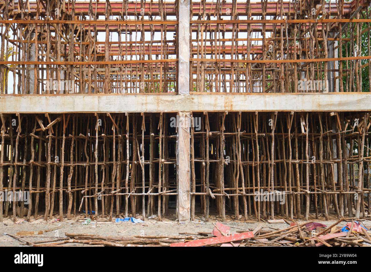 Old construction style concrete form, support work made of wood, logs. Building a new temple at Wat Sisaket in Vientiane, Laos Stock Photo