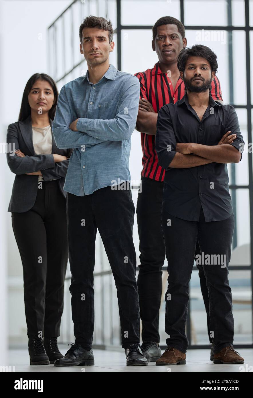 Friends smiling and standing together in office Stock Photo