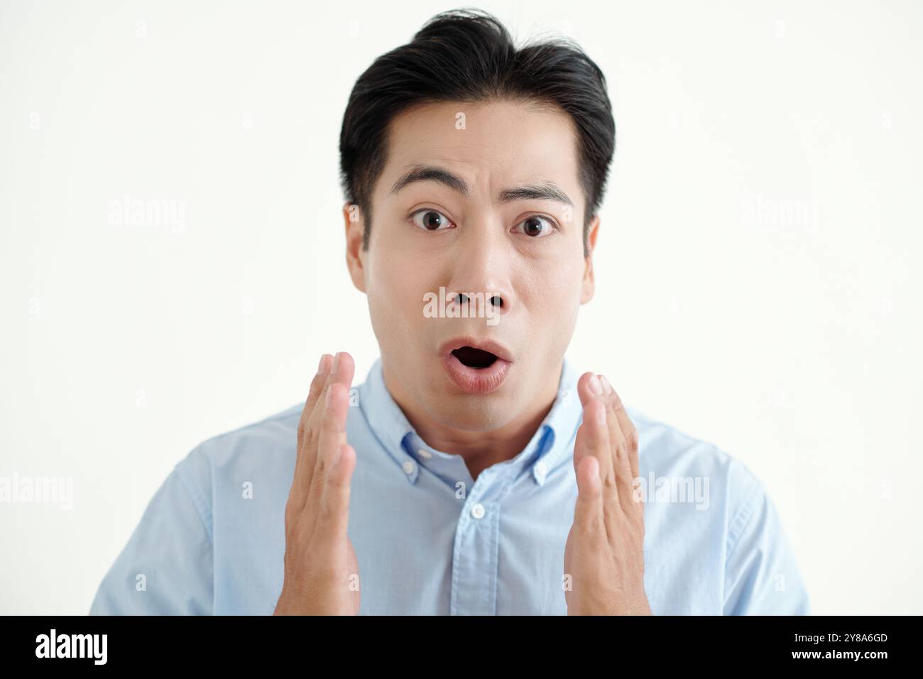 Young Man Looking With Surprised Expression Stock Photo