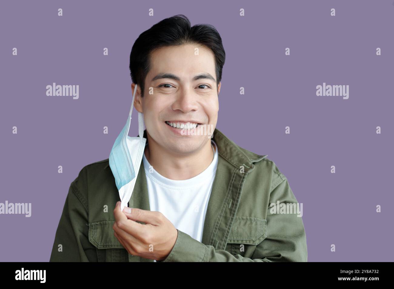 Smiling Man Taking The Mask Off Stock Photo