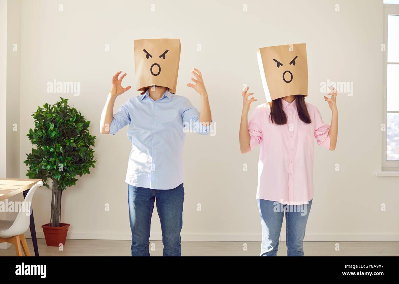 Faceless angry couple man and woman standing in the living room at home ...