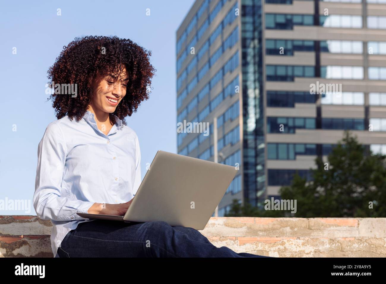 female entrepreneur working remotely on laptop Stock Photo