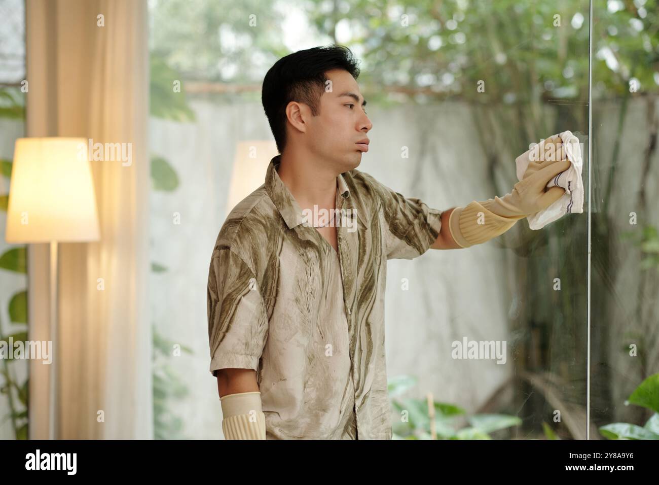 Man Cleaning The Panoramic Window Stock Photo