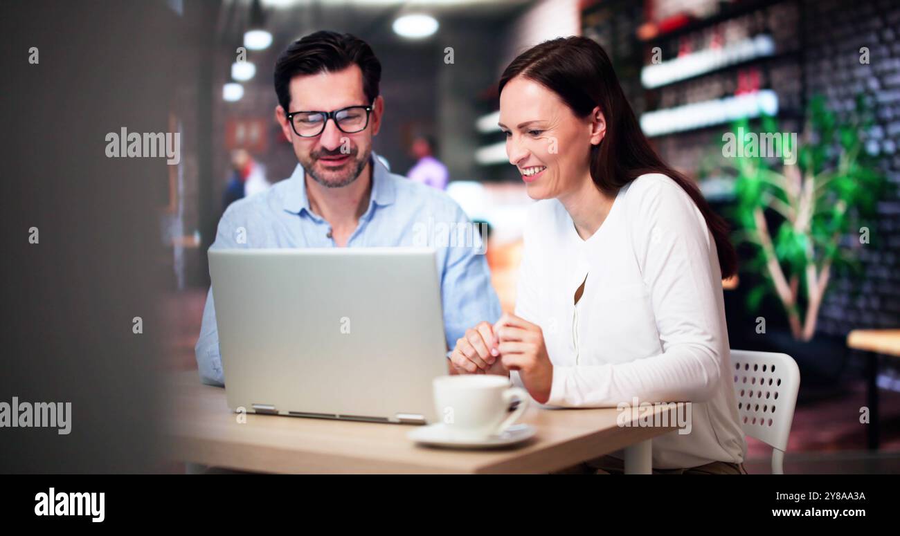 Coworkers Using Technology Lifestyle. Man And Woman Drinking Coffee In Cafe Stock Photo