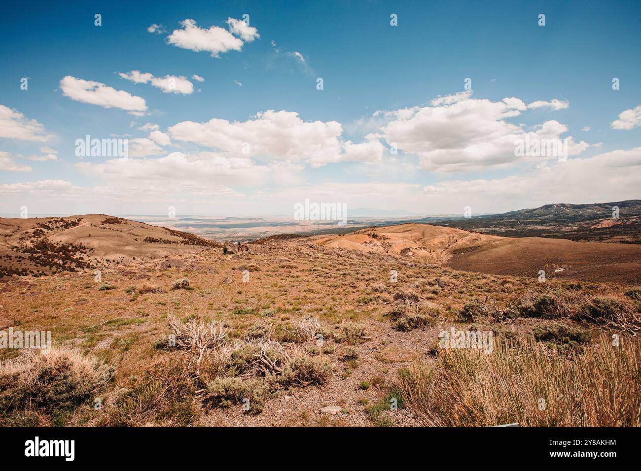 Expansive desert landscape with hills under a bright, partly clo Stock ...