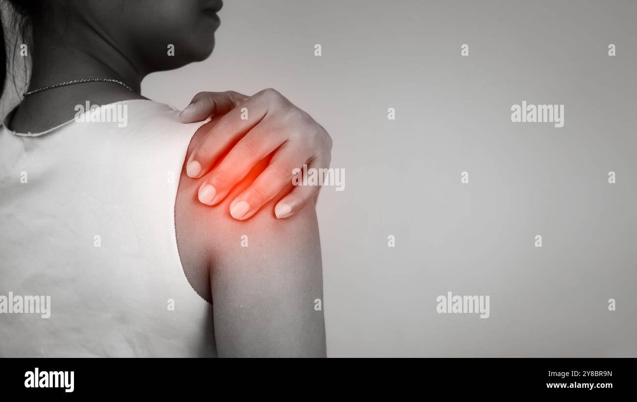 Woman with acute pain shoulder with neck pain on gray background ...