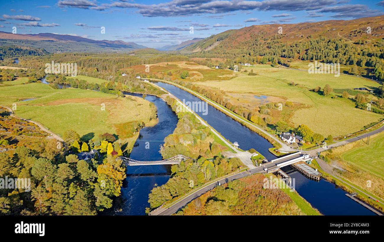 Bridge of Oich or Victoria Bridge Aberchalder Scotland a white suspension bridge the nearby Caledonian Canal and Swing Bridge and A82 road in autumn Stock Photo